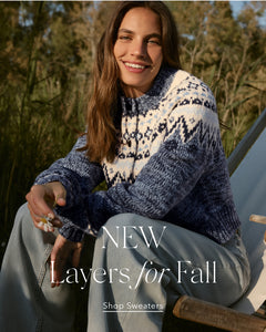  Woman wearing a patterned sweater with text 'NEW Layers for Fall' and 'Shop Sweaters'.