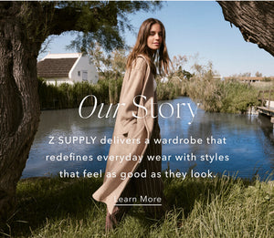  Woman in a beige coat standing by a pond with text overlay about Z SUPPLY clothing brand.