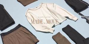  Beige sweatshirt with text on a light blue background surrounded by folded pants.