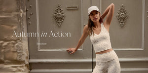  Woman in athletic wear posing in front of a decorative door with 'Autumn in Action' text.
