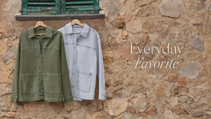  Two shirts hanging on a stone wall with 'Everyday Favorite' text.