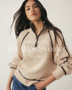  Woman wearing a beige sweater with black accents, introducing 'The Alps Sweater' with text overlay.
