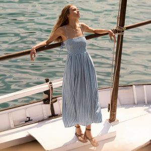SweatersLooking Glass Crochet Polo Sweater Woman in a striped dress standing on a boat with water in the background