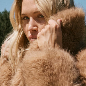  Woman wearing a fur coat with a blurred background