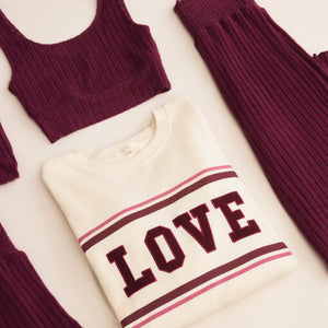 DressesCallahan Crochet Midi Dress Folded cream sweater with 'LOVE' text in maroon on a light background