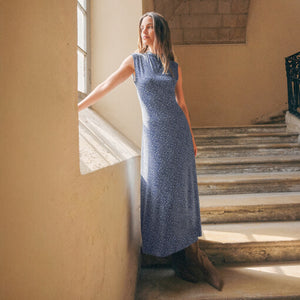 TopsSirena Rib Tank Woman in a blue dress standing on a staircase in a sunlit room