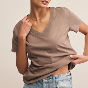 SweatersLooking Glass Crochet Polo Sweater Person wearing a brown V-neck shirt and blue jeans on a beige background
